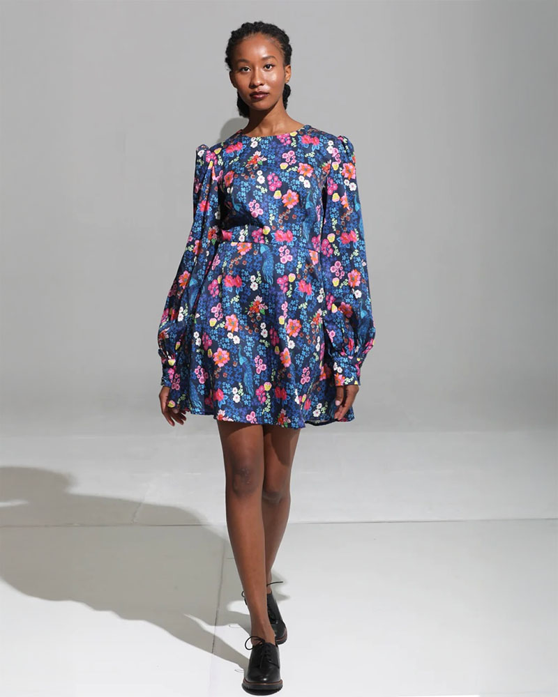 Model in colorful floral dress.