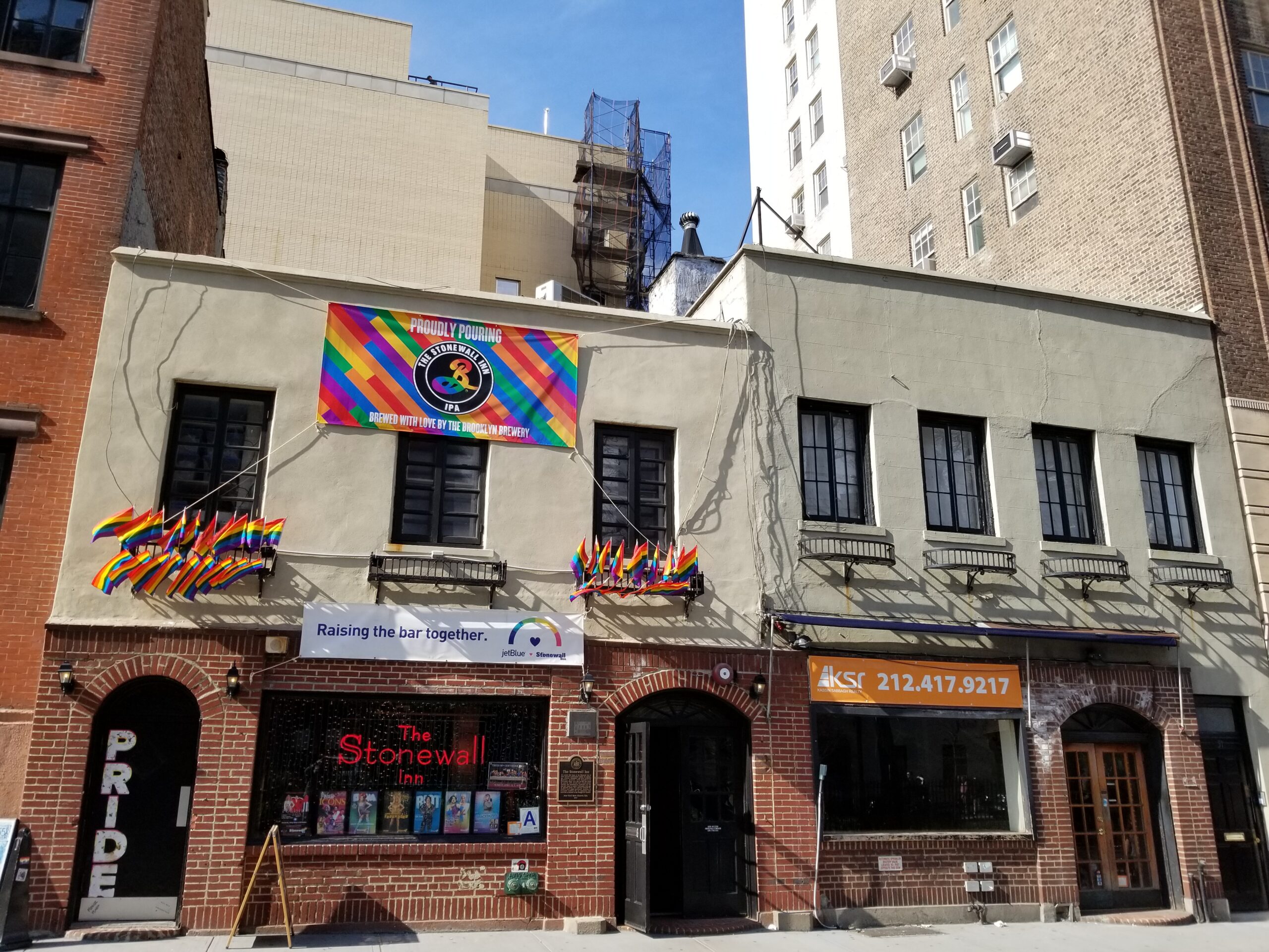 A banner and flags on The Stonewall Inn.