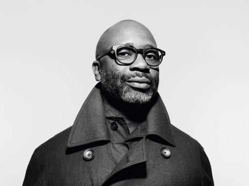 Black and white portrait of artist Theaster Gates.